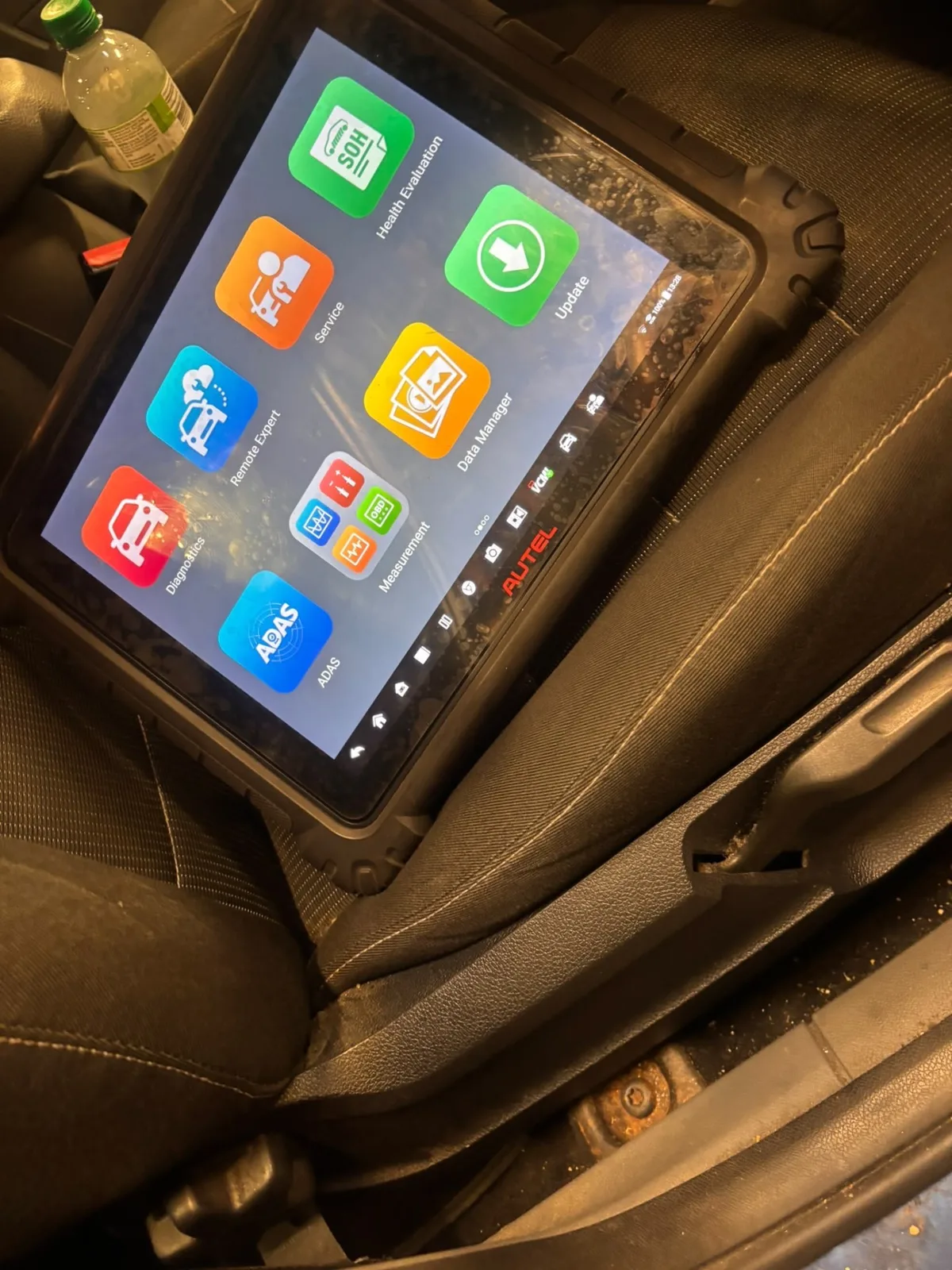 Autel diagnostic tablet in use inside a customer's vehicle at Sweeney's Garage